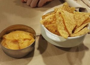 Nachos with carrot cheese dip at Dolce Pizza y Los Veganos - Hipolit Lazaro in Barcelona