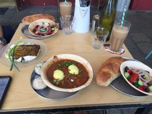 Chickpea omelette/labne/shakshuka with tofu eggs/toasted focaccia/ice coffee at Alegria in Tel Aviv