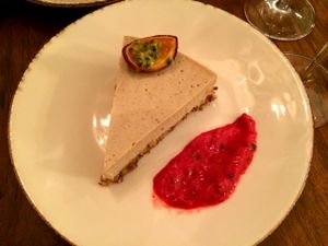 Lavender cheesecake with raspberry coulis and a passionfruit garnish at Bites and Wines in Antwerpen