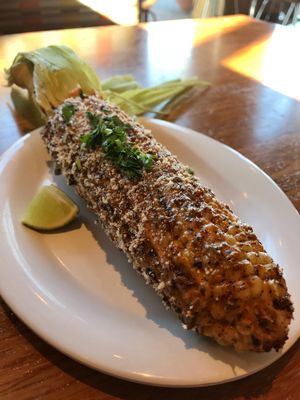 The street corn is on their summer menu & it's so good! It's a ";Mexican style"; elote with chipotle aioli & Parmesan cheese. It's amazing. at Veggie Grill by Next Level - Tustin Marketplace in Irvine