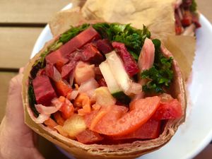 Wrap comes loaded with fresh, raw, vegan veggie and tahini. at Green Cup Cafe in Fort Myers