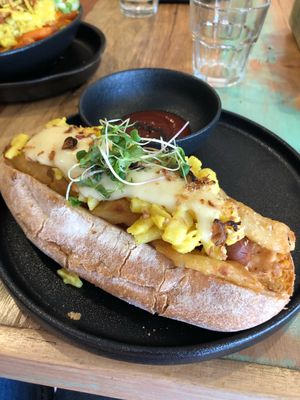 Bratwurst sausage with onion rings and Mac n cheese  at Adam & Eve in Bendigo