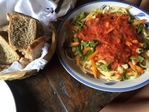 Delicious pasta with vegetables and bread basket. at La Paz in San Marcos La Laguna