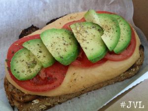 Smothered Toast...whole wheat with red pepper hummus, tomato and avacado ($2.50)  at Garden Truck in Jacksonville