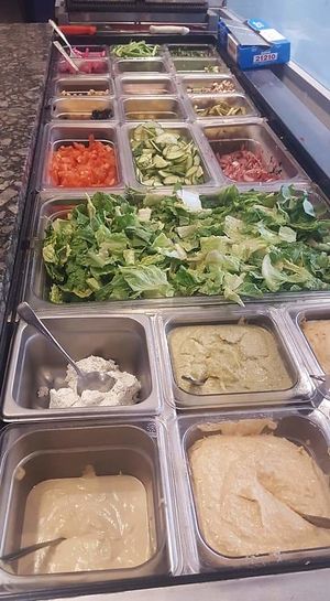 A bar of fresh veggies! You choose your entree (pita wrap, nacho, rice bowl or salad), then load it up! at Blue Grill in Milford