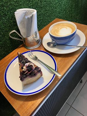 Vegan cheese cake with blueberry and flat white with oat milk  at KIRAS - Totoriu 7 in Vilnius