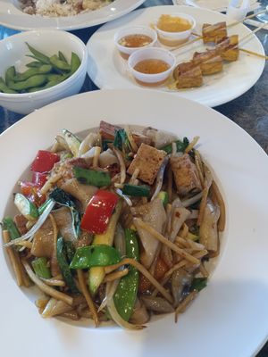 Drunken man noodles with fried tofu. Back: edamame and tofu satay. at Thai Meal in Plantation