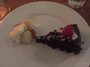 Vegan Chocolate Cake Slice with Small Fruit Salad Side at Black Bear Cafe in Belfast