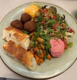 Focaccia, falafel, hummus, quinoa salad, pesto roasted potatoes, marinated tomatoes, aioli, roasted fennel + carrots  at Roots Kitchen in Turku