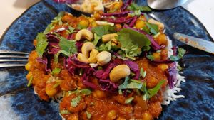 Red curry with rice, chickpeas, cashew nuts, and coriander at Roots Kitchen in Turku