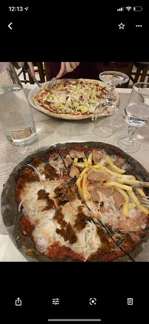 Mine was Half vegan tuna/half würstel and chips, other pizza was vegan kebab  at Il Papiro in Milan
