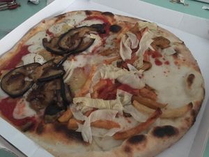 Half parmigiana - half kebab pizza at Il Papiro in Milan