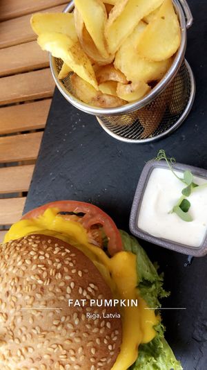 Cheeseburger, French fries and dip. at Green Pumpkin in Riga