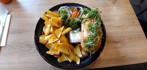 Vegan hotdog with LOTS of mild mustard, arugala, and onion rings. at Green Pumpkin in Riga