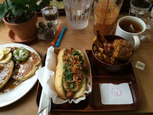 Brunch: 'Dogter Dre' hot dog (with guacamole), side dish of plantains and corn, pancakes, juice and hot beverage. All vegan. at Le Tricycle in Paris