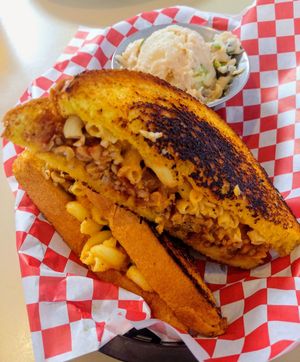 Hawaiian bread filled with smoked tempeh, vegan mac n' cheese and MFT chocolate rasberry bbq sauce and a side of vegan potato salad at BBQ4Life in Boise