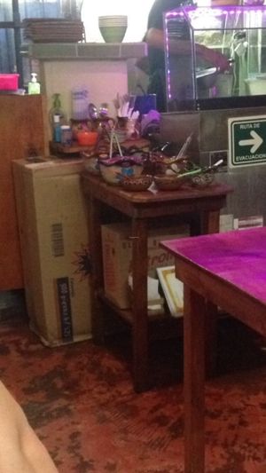 Cart with various condiments and sauces at Falafel Nessya in Playa Del Carmen