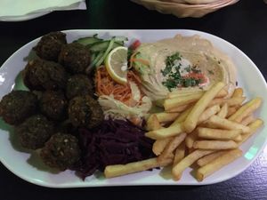 ‘Premium plate - vegetarian’ = falafel, houmous, salads, fries served with pitta  at Olive Tree Hummus Original in Budapest