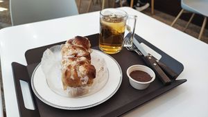 Cinnamon roll with peppermint tea. The peanut sauce was offered at The Bread Blue - Nogosan in Seoul