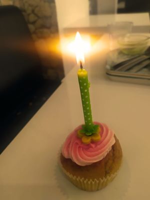 My cupcake with the candle my friend brought. :) at Les Delices De Gigi in Le Perreux