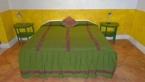 This spacious simply decorated air-conditioned room has a king-sized bed, private bathroom with shower, a ceiling fan, a separate dressing area and an uncluttered Mexican decor. at Hotel MedioMundo in Merida