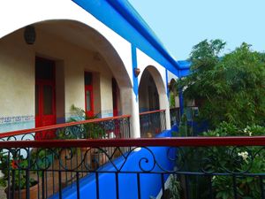 Upstairs corridor surrounding the  tropical garden central patio.  at Hotel MedioMundo in Merida