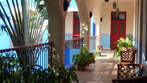 Upstairs corridor surrounding the  tropical garden central patio.  at Hotel MedioMundo in Merida