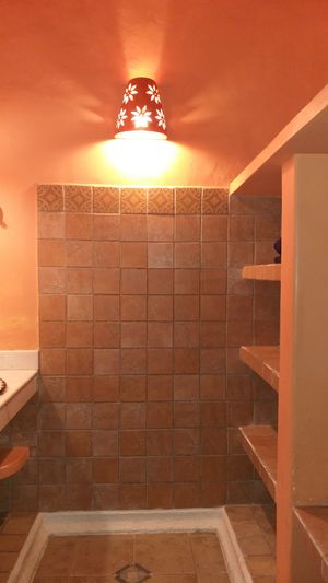 dressing area, with sink and closet at Hotel MedioMundo in Merida