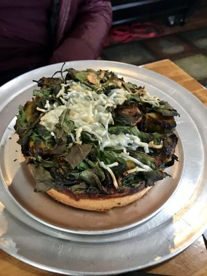 Mini deep dish pizza filled with veggies, San Marzano tomato sauce, and Impossible sausage. at Fortuitea Cafe and Bakery in Washington