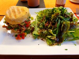 Vegan burger with spelt herb roll, falafel patty, avocado cream, caramelized onions, vegetable cubes and salad at Frucht and Genuss in Dusseldorf