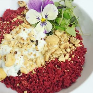 Beetroot couscous with roasted hazelnuts and yogurt sauce with capers  at El Vergel Veggie Restaurant in Tarragona