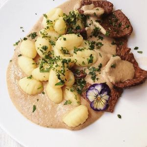 Soya steaks with potato gnocchi and mushrooms and pine nuts sauce  at El Vergel Veggie Restaurant in Tarragona