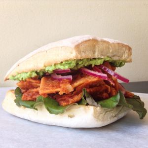Chilakiller: torta de chilaquiles con salsa hecha en casa, spread de frijol, guacamole, kale, cebolla curtida.

Chilaquiles with homemade salsa, bean spread, kale, guacamole and onions in torta bread  at Veggies Are Us in Tijuana