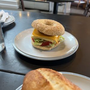 Sausage and Egg Bagel, add lettuce and tomato  at Democracy* in Hamilton