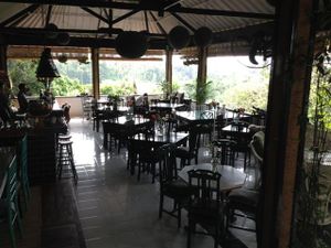 view of restaurant facing the balcony overlooking the rice terraces and ridge at Elephant Cafe in Ubud