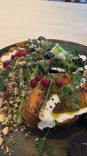 Jacket Potato Club: Grilled sweet potato, tahini yoghurt, chimichurri, roasted vegetables, dukkah, pomegranate, fresh herbs. A delicious whole food option!   at GYS - Voorstraat in Utrecht