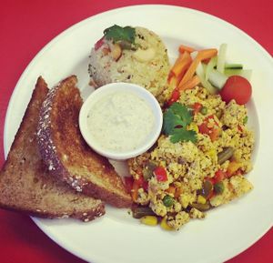 Scrambled Tofu, Upma (roasted Cream of Wheat with vegetables), Coconut Chutney, and Toast at Good Eden in New Orleans