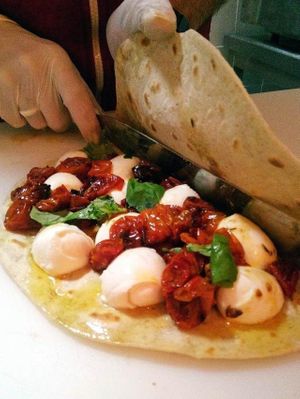 Vegetarian Piadina. San Sebastiano with confit tomatoes, mozzarella di bufala DOP and basil pesto at Santapiadina in Lisbon