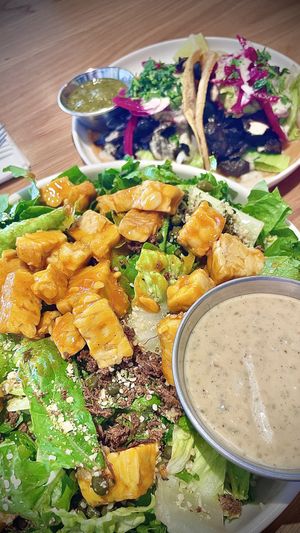 CAESAR CRUNCH SALAD , with Buffalo Tempe and the smoky mushroom Asada tacos! 🌮   at Veggie Grill by Next Level in Pasadena