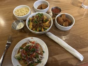 Clockwise from top left: Mac and cheese, chicken nuggets, fried cheese bites, fish taco, loaded fries (centre)   at Veggie Grill by Next Level in Pasadena