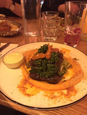Flavorful seitan steak lined with sweet potato mash, vegan mayo on the side at ONDA in Helsinki