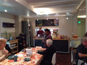 Dining room and front counter of cafe at Sunday morning brunch. at World Peace Cafe in Baltimore