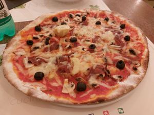 Pizza with vegan ham, black olives, mushrooms and  artichoke at Origano Trevi in Rome