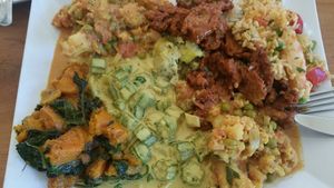 a close up of the buffet from indian themed tuesdays. Almost perfect except for the tikka on the right: seasoned perfectly but they need to get a less processed vegan meat  at Jungle Cafe in Brooklyn