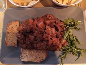 Vegan seitan goulash with tomato sauce, potatoes and mushrooms at Il Vegano Bistrot in Florence