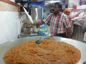 cooking on big hot Plate at Ananda Bhavan - Syed Alwi Rd in Central Singapore