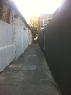 Walk down long narrow alley-way, at sign, to get to cafe at Blue Gate Cafe  in Chiang Mai