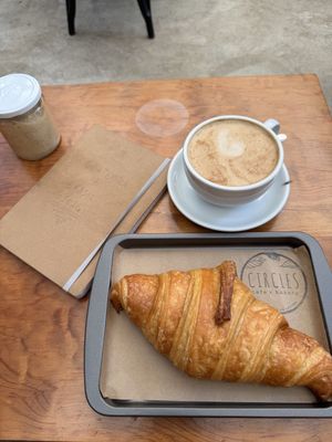 Vegan croissant with cappuccino  at Circles Cafe and Hostel in San Marcos La Laguna