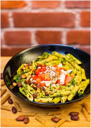 Glutenfree spinach pasta with tofu, zucchini and roasted almonds. at Vegan Inspiratsioon in Tallinn