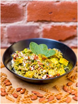 Glutenfree spinach pasta with tofu, zucchini and roasted almonds at Vegan Inspiratsioon in Tallinn